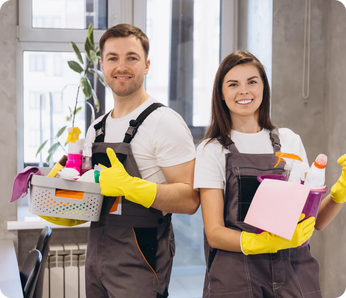 Two cleaners holding cleaning products