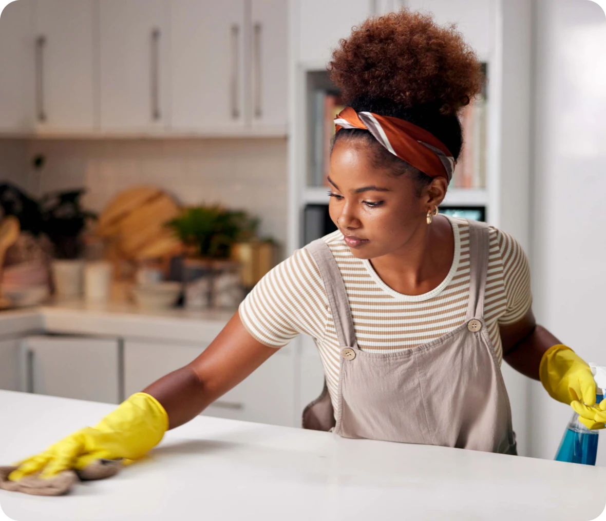 Woman tidying up kitchen countertop